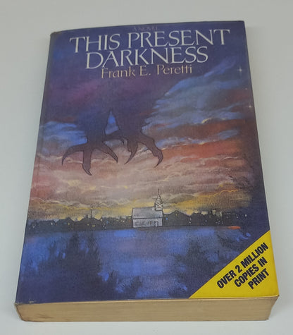 This Present Darkness by Frank E. Peretti