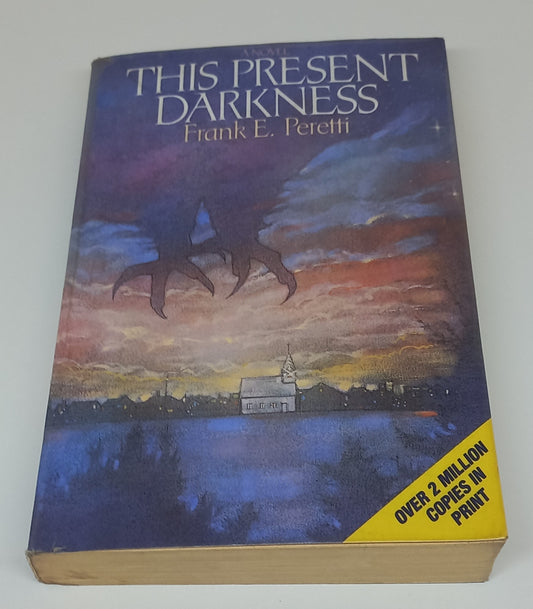 This Present Darkness by Frank E. Peretti