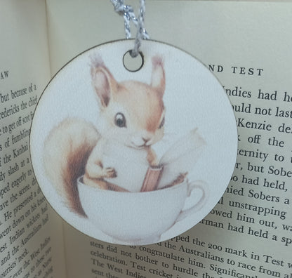 Baby Squirrel Reading A Book In A Teacup